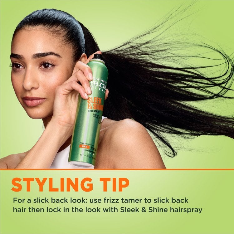 A model demonstrates the use of Garnier Fructis Sleek & Shine hairspray. A styling tip advises using frizz tamer for a slicked-back look.